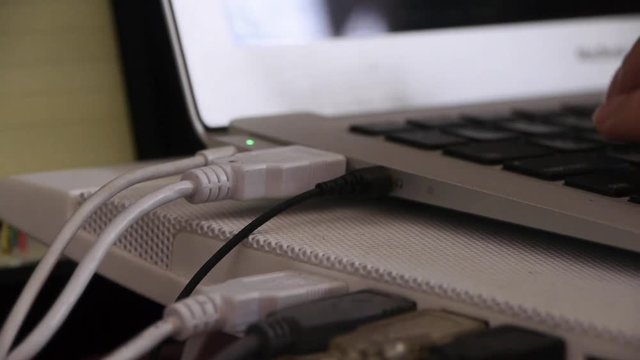 Computer Literate Operator,NoteBook Keyboard,side of macbook pro laptop showing USB and power conections.