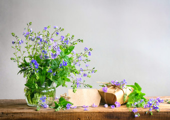 Bouquet of small delicate blue flowers of veronica and gift box