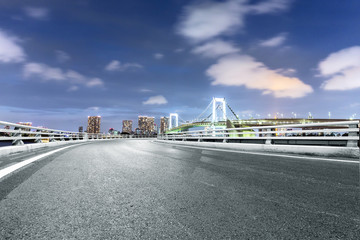 empty road with suspension bridge in modern city