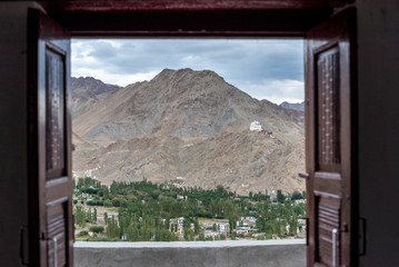 Top View of Leh from open wooden window of the light room in Shanti Stupa, Leh Ladakh, Kashmir. North of India. Asia Travel