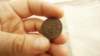 Denga 1734 Old Russian Czarist Copper Coin Emblem Two-Headed Eagle Behind White Material Close up