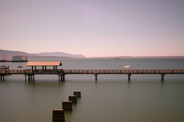 Long exposure of a long walkway over the water