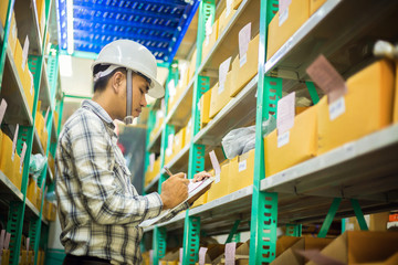 Asian man check agricultural equipment stock with smile