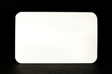 White business card with rounded edges on black