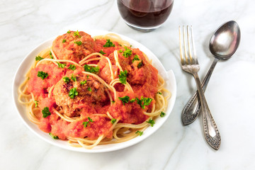 Meatballs and pasta dish with red wine and copyspace