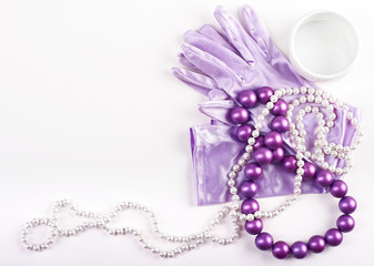 Women's beaded necklace from round colorful pearl beads and gloves isolated on white background. Female accessories.