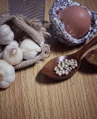 Raw pork, egg, pepper and garlic background