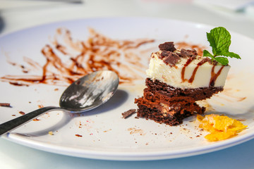 Cake crumbs leftovers on white dish with spoon.