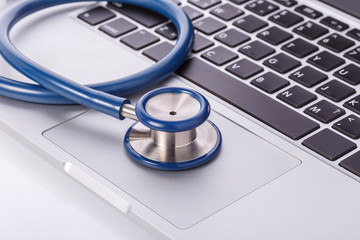 Computer notebook or laptop and stethoscope. Checking virus or damaged check up concept.