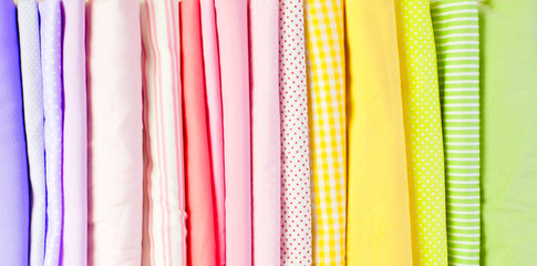 Cotton colored fabric. Background of white wood.