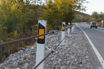 Traffic Barrier, safety road on road. Asphalt road texture with white stripe. The car on the road