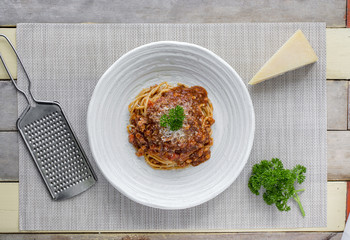 Spaghetti bolognese with cheese and pasley