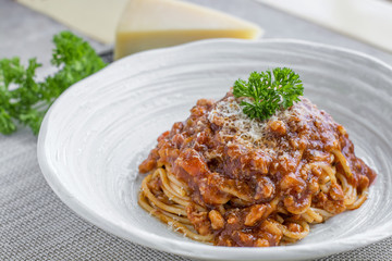 Spaghetti bolognese with cheese and pasley
