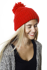 Beautiful young woman, with long blond hair and blue eyes. Young pretty woman, with red bobble cap