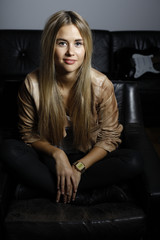 Fototapeta premium Beautiful young woman, with long blond hair and blue eyes. Young pretty woman, with leather jacket