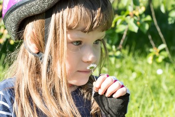 Cute little girl with a daisy portrait, green background, natural