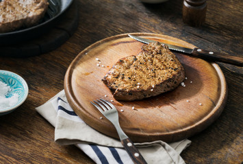 Grilled beef steak on a wooden board with copy space