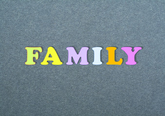 FAMILY word on black board background composed from colorful abc alphabet block wooden letters, copy space for ad text. Learning english concept.