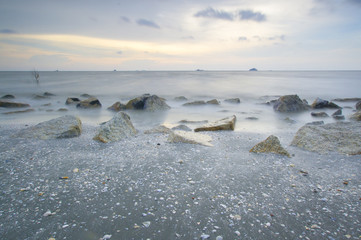 Scenery of sunset captured at Pantai Remis, Selangor, Malaysia. The motion of cloud and water is due to long exposure effect. Low light