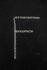 Letter F drawn with white chalk on blackboard. Education, school concept
