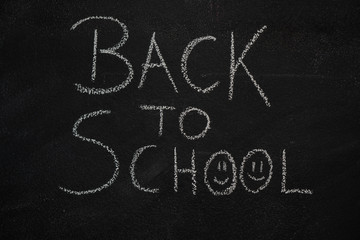 Back to school text written with chalk on blackboard. Education, school concept