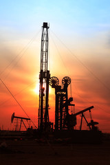 In the evening, the silhouette of oilfield derrick