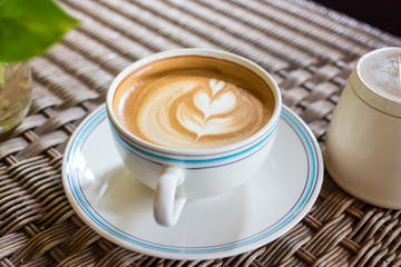 Coffee latte cup with milk on the table
