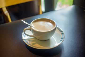 Coffee latte cup with milk on the table