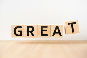Surreal abstract geometric floating wooden cube with word "GREAT" concept float on wood floor white background