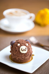 Chocolate cake face bear; sweets and drinks; soft and select focus.