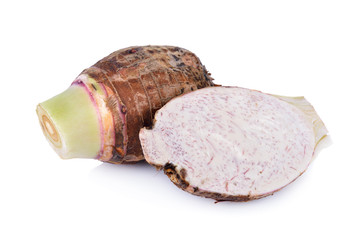 whole and cut raw taro on white background