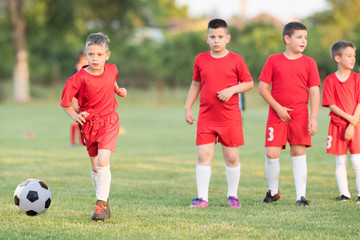 Kids soccer football - children players match on soccer field