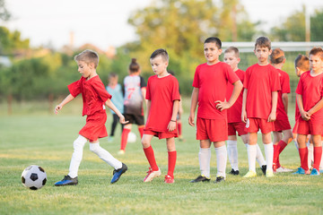 Kids soccer football - children players match on soccer field