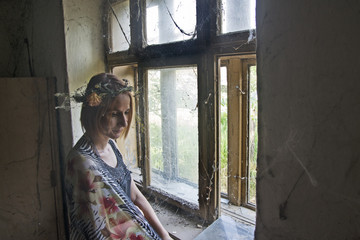 Young girl in the old window