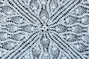 White crochet fabric on black background