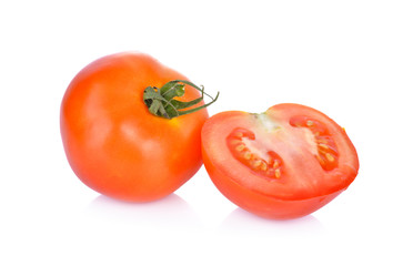 whole and portion cut fresh tomato on white background