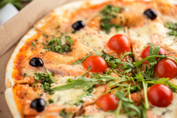 Colorful italian pizza with seafood salmon, arugula