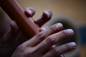 Playing Wooden Flute © Logan