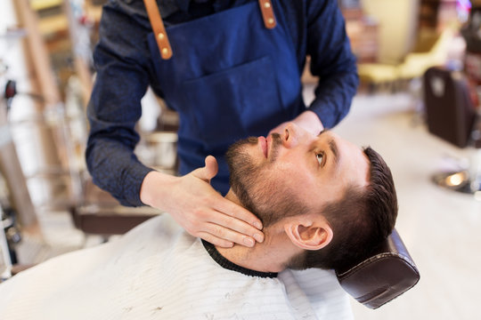 Barber Applying Aftershave Lotion To Male Neck