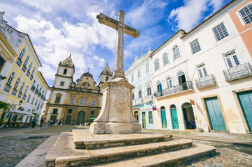 Bright view of Pelourinho in Salvador, Brazil, dominated by the large colonial Sao Francisco Christian stone cross in the Anchieta Plaza