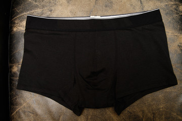 black underpants for men on black background, isolated