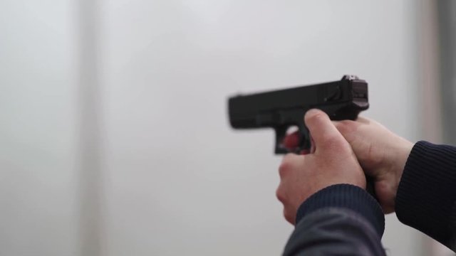 Tactical shooting range, man shoots a pistol on the target.
