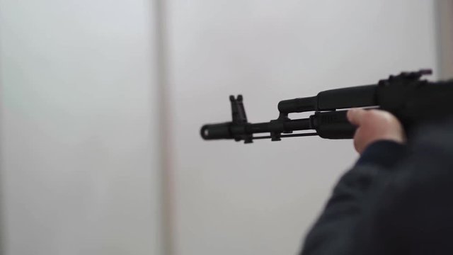 Tactical shooting range, man shoots a rifle Ak-47 on a target.
