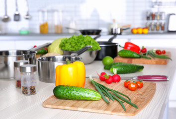 Fresh vegetables and utensils for cooking classes on wooden table