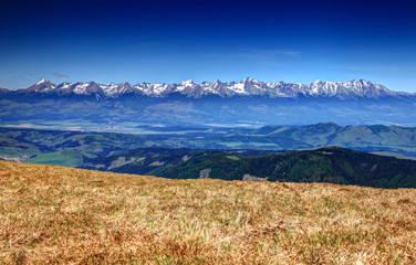 View of the entire High Tatras range from Krivan to Rysy, Vysoka, Gerlach, Ladovy and Lomnicky peaks, before them Vah and Poprad valleys, from Kralova Hola peak, Low Tatras, Slovakia, Europe © nogreenabove2k