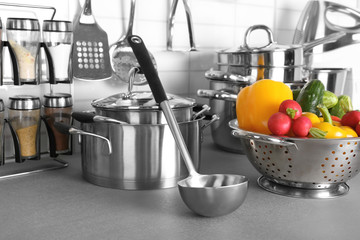 Utensils and vegetables for cooking classes on table in kitchen