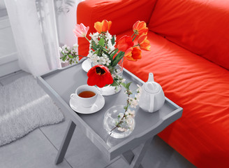 Interior of modern veranda with beautiful flowers on table