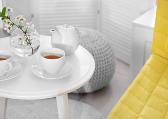 Fototapeta na wymiar Tea set on table in modern veranda interior