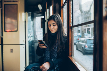 young woman using smartphone in bus