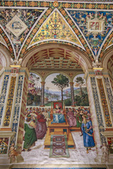 Fototapeta na wymiar Fresco painted by Umbrian Bernardino di Betto, called Pinturicchio, probably based on designs by Raphael in Piccolomini Library, Cathedral in Siena